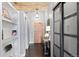 Hallway featuring hardwood floors, overhead lighting, built-in shelving, and a decorative entry table at 1301 Wazee St # 3C, Denver, CO 80204