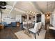 Bright living room with exposed ductwork, modern lighting, and open floor plan to the kitchen and dining area at 1301 Wazee St # 3C, Denver, CO 80204