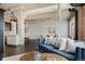 Open floor plan showcasing exposed ceiling and ductwork, brick accent wall, hardwood floors, and contemporary furnishings at 1301 Wazee St # 3C, Denver, CO 80204