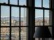 Window view of mountains, city buildings, and an amusement park at 1301 Wazee St # 3C, Denver, CO 80204