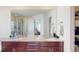 Spacious bathroom featuring a dual vanity, a shower, and a large mirror at 3062 Grizzly Peak Dr, Broomfield, CO 80023