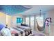 Bedroom with a comfy hammock chair, large windows, and blue mandala tapestry at 3062 Grizzly Peak Dr, Broomfield, CO 80023