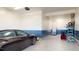 Clean two car garage has speckled flooring, painted walls, and an additional entrance at 3062 Grizzly Peak Dr, Broomfield, CO 80023