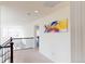 Hallway featuring an abstract painting, dark railing and natural light at 3062 Grizzly Peak Dr, Broomfield, CO 80023