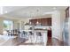 Modern kitchen featuring a large island, stainless steel appliances, and breakfast bar at 3062 Grizzly Peak Dr, Broomfield, CO 80023