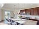 Spacious kitchen featuring granite countertops, an island with seating, and stainless appliances at 3062 Grizzly Peak Dr, Broomfield, CO 80023