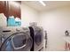 Laundry room featuring Samsung washer and dryer and storage cabinets at 3062 Grizzly Peak Dr, Broomfield, CO 80023