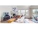 Bright living room with fireplace, large windows, and modern furniture at 3062 Grizzly Peak Dr, Broomfield, CO 80023