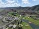 Overhead scene of golf course and neighborhood nestled among rock formations against a skyline at 6405 Eagle Feather Trl, Littleton, CO 80125