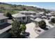 Stunning aerial view of a luxurious home with a tile roof and a large driveway at 6405 Eagle Feather Trl, Littleton, CO 80125