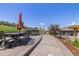 Backyard patio with dining set, umbrella, hot tub, and views of the surrounding landscape at 6405 Eagle Feather Trl, Littleton, CO 80125