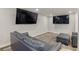 Finished basement media area with a large-screen TV and comfortable seating at 6405 Eagle Feather Trl, Littleton, CO 80125
