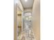Hallway leading to a bathroom with tile flooring, modern fixtures, and a separate walk-in closet at 6405 Eagle Feather Trl, Littleton, CO 80125