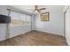 Cozy bedroom with hardwood floors, a ceiling fan, and plantation shutters for natural light and privacy at 6405 Eagle Feather Trl, Littleton, CO 80125