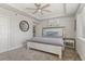 Bright bedroom with a white paneled bed frame, tray ceilings and a ceiling fan at 6405 Eagle Feather Trl, Littleton, CO 80125