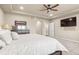 Large bedroom with a ceiling fan, and a wall-mounted television at 6405 Eagle Feather Trl, Littleton, CO 80125