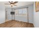Bright bedroom with wood floors, shutters, and neutral decor at 6405 Eagle Feather Trl, Littleton, CO 80125