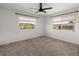 Bright bedroom with large windows offering views of the neighborhood at 6405 Eagle Feather Trl, Littleton, CO 80125