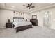 Primary bedroom featuring a tray ceiling, ceiling fan, and ensuite bathroom access at 6405 Eagle Feather Trl, Littleton, CO 80125