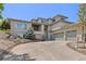Spacious home featuring an attached three-car garage, elegant landscaping, and a welcoming front entrance at 6405 Eagle Feather Trl, Littleton, CO 80125
