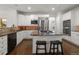 Updated kitchen with stainless appliances, granite counters, center island, and dark hardwood floors at 6405 Eagle Feather Trl, Littleton, CO 80125