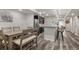 An open kitchen features modern appliances, stone backsplash, a large island, and barstool seating at 6405 Eagle Feather Trl, Littleton, CO 80125