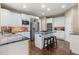 Modern kitchen with stainless steel appliances, granite countertops, a center island, and white cabinetry at 6405 Eagle Feather Trl, Littleton, CO 80125