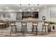 Stylish kitchen with bar seating, modern appliances, and sleek countertops for entertaining at 6405 Eagle Feather Trl, Littleton, CO 80125