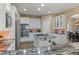 Well-appointed kitchen featuring granite countertops, modern appliances, a center island, and custom cabinetry at 6405 Eagle Feather Trl, Littleton, CO 80125