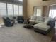 Comfortable living room with plush seating, neutral decor, large windows, and an open floor plan at 6405 Eagle Feather Trl, Littleton, CO 80125