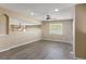 Spacious, neutral-toned living area with hardwood floors, large window, and a ceiling fan at 6405 Eagle Feather Trl, Littleton, CO 80125