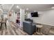 A spacious living room has recessed lights, wood floors, a dark sofa, and a large entertainment area at 6405 Eagle Feather Trl, Littleton, CO 80125