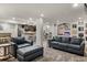 Open-concept living room with kitchen, bar seating, and entertainment area with comfortable seating at 6405 Eagle Feather Trl, Littleton, CO 80125
