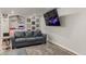 A spacious living room has an entertainment center, comfortable seating, and a large screen TV at 6405 Eagle Feather Trl, Littleton, CO 80125
