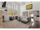 Spacious living room featuring fireplace, tall windows, and open floor plan at 6405 Eagle Feather Trl, Littleton, CO 80125
