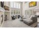 Inviting living room with a stone fireplace, large windows, and a comfortable sectional couch, great for relaxing at 6405 Eagle Feather Trl, Littleton, CO 80125