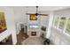 Sun-filled living room boasts tall ceilings, a stone fireplace, and open layout perfect for entertaining at 6405 Eagle Feather Trl, Littleton, CO 80125