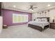 Serene main bedroom with a large window, soft carpet, and a tray ceiling, creating a relaxing retreat at 6405 Eagle Feather Trl, Littleton, CO 80125
