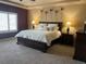 Serene main bedroom featuring soft lighting, a plush bed, stylish decor, and a tray ceiling at 6405 Eagle Feather Trl, Littleton, CO 80125