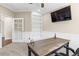 Bright office with built-in shelves, large desk, and plenty of natural light with wainscoting and a ceiling fan at 6405 Eagle Feather Trl, Littleton, CO 80125