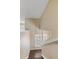 Bright staircase with white trim and banister, featuring hardwood steps and natural light from window at 6405 Eagle Feather Trl, Littleton, CO 80125