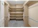 Spacious walk-in closet with ample shelving, rod space, and carpeted flooring for organization at 6405 Eagle Feather Trl, Littleton, CO 80125