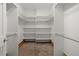 A spacious walk-in closet featuring built-in shelves and rods for optimal organization at 6405 Eagle Feather Trl, Littleton, CO 80125