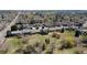 Aerial view of a residential neighborhood bordering a green space with mature trees and walking path at 1225 Baker St, Longmont, CO 80501