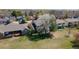 Aerial view showing homes with decks and yards, set against a backdrop of blooming trees at 1225 Baker St, Longmont, CO 80501