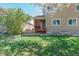 Backyard of a two-story house with a wooden porch and gravel at 1225 Baker St, Longmont, CO 80501