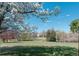 Landscaped backyard with a view of a lush yard under a blossoming tree at 1225 Baker St, Longmont, CO 80501