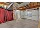 Unfinished basement with visible ductwork, access to stairs, and a single window at 1225 Baker St, Longmont, CO 80501