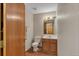 Traditional bathroom with a single sink vanity and a mirror with decorative lighting above at 1225 Baker St, Longmont, CO 80501