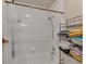 Clean bathroom with tiled walls, shower and bathtub combo, and ample storage for towels at 1225 Baker St, Longmont, CO 80501